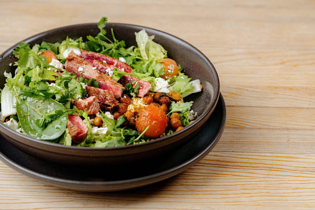 Salad with meat in a bowl at “DOCK”